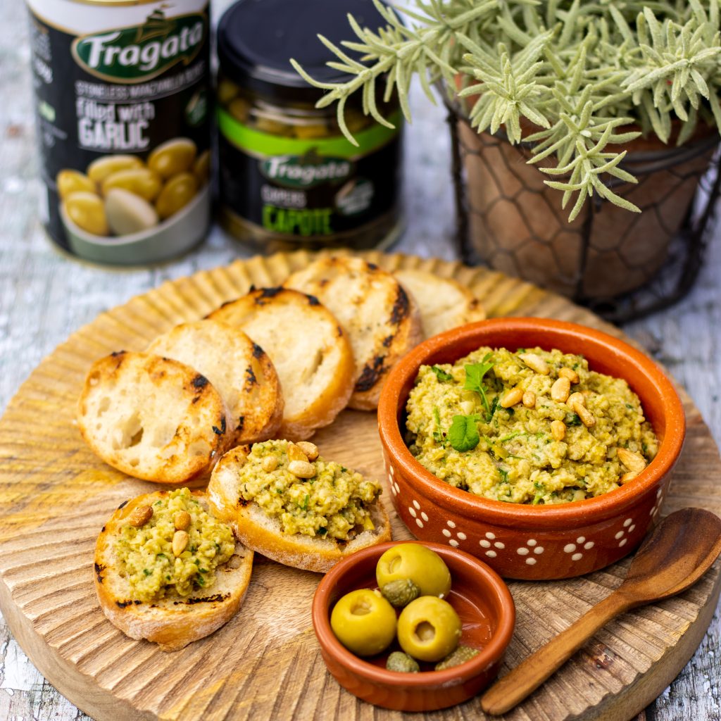 Garlic Manzanilla olive tapenade with a side dish of bread and olives. 